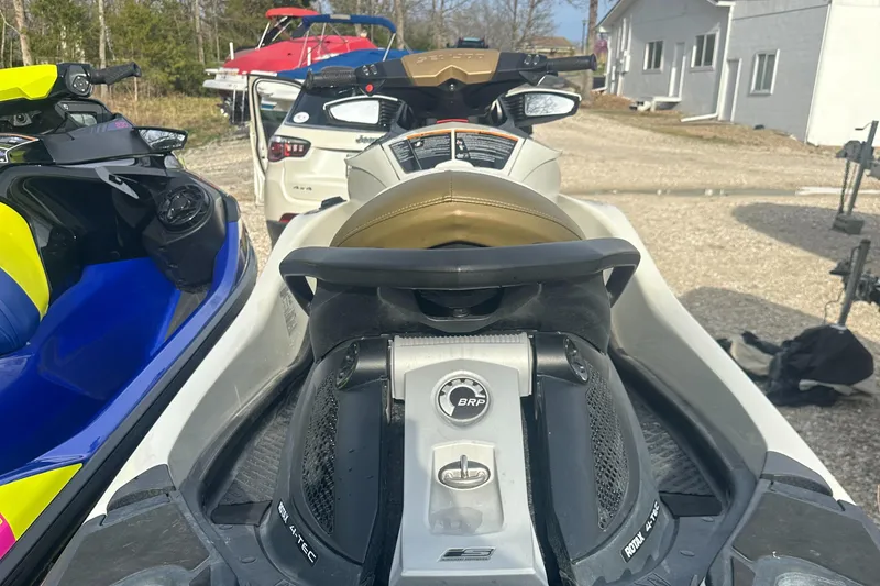 Slide: The Image of 2021 Sea-Doo Wake Pro 230 jet ski parked outdoors, showcasing sleek design and controls. - 23