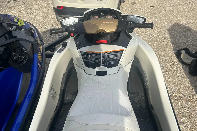 Slide: The Image of 2021 Sea-Doo Wake Pro 230 jet ski, white seat, handlebars, parked on gravel. - 25