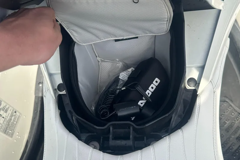 Slide: The Image of Open storage compartment of 2021 Sea-Doo Wake Pro 230 with accessories inside. - 27