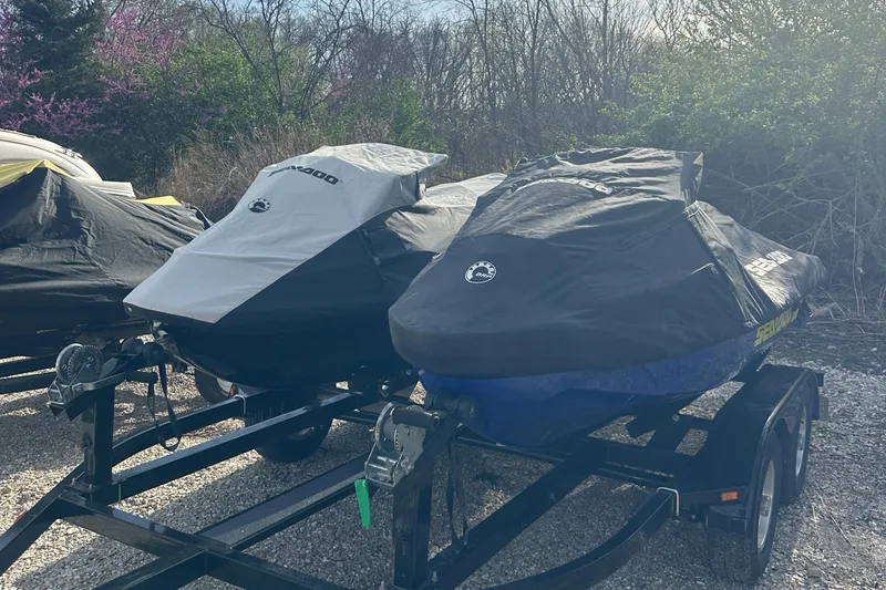 Slide: The Image of 2021 Sea-Doo Wake Pro 230 jet skis covered on trailers, parked outdoors. - 31
