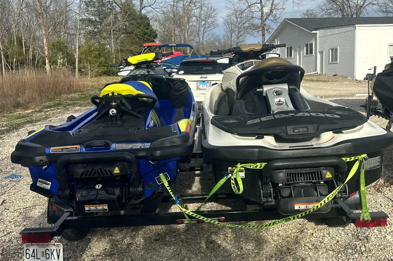 Slide: The Image of Two Sea-Doo Wake Pro 230 jet skis on a trailer, parked outdoors. - 4