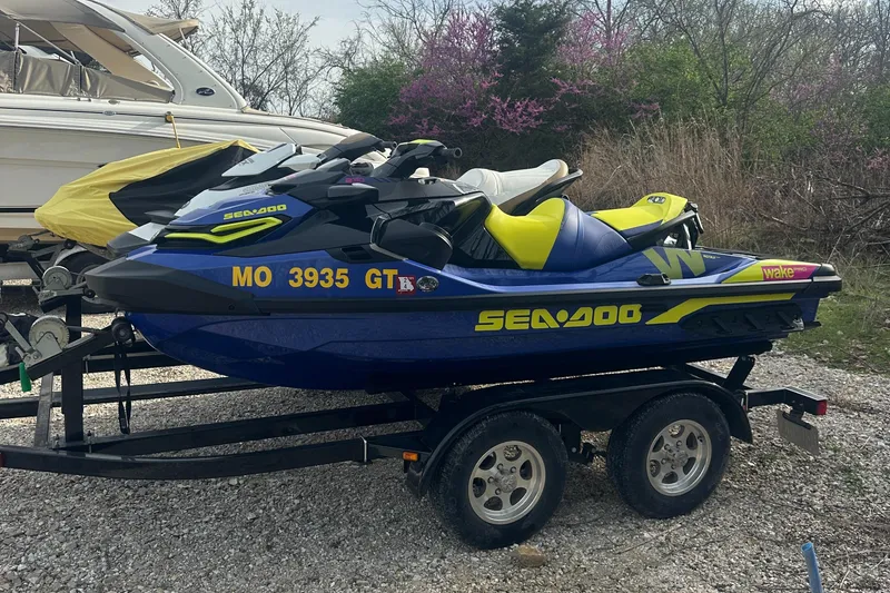 Slide: The Image of 2021 Sea-Doo Wake Pro 230 jet ski on trailer, parked outdoors. - 6
