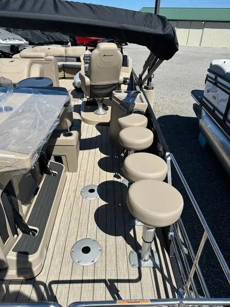 Slide: The Image of 2023 Starcraft CX25DL Bar pontoon boat with beige seating and bar stools. - 12