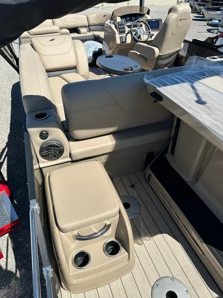 Slide: The Image of 2023 Starcraft CX25DL Bar pontoon boat interior with beige seating and modern amenities. - 14
