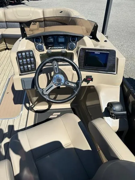 Slide: The Image of 2023 Starcraft CX25DL Bar boat dashboard with steering wheel and control panel. - 5