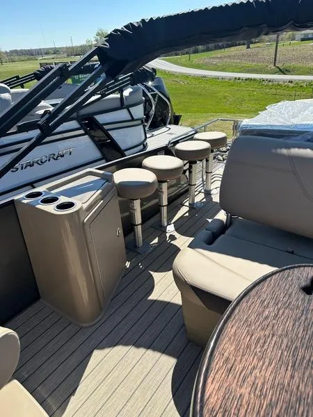 Slide: The Image of 2023 Starcraft CX25DL Bar pontoon boat interior with seating and bar stools. - 7