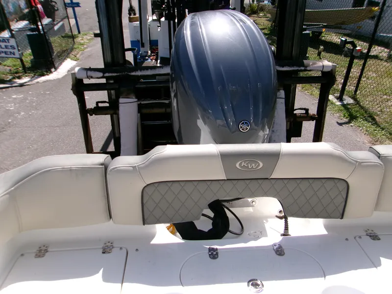 Slide: The Image of 2025 Key West 203 FS boat with Yamaha outboard motor, docked and ready for use. - 13