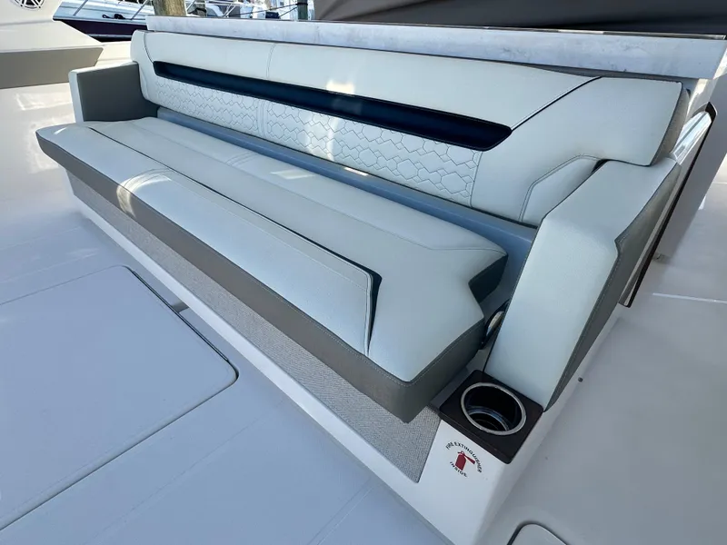 Slide: The Image of Luxurious seating on 2022 Tiara Yachts 43 LS, featuring elegant design and integrated cup holder. - 16