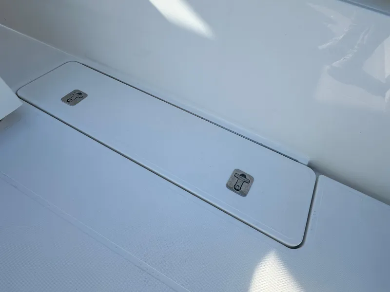 Slide: The Image of 2022 Tiara Yachts 43 LS deck storage compartment with secure latches. - 17