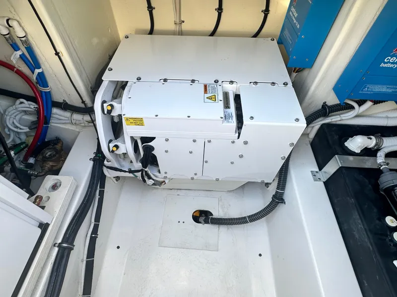 Slide: The Image of 2022 Tiara Yachts 43 LS engine compartment with modern equipment and wiring. - 20