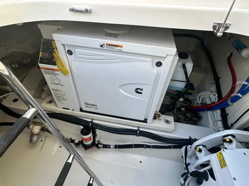 Slide: The Image of 2022 Tiara Yachts 43 LS engine compartment with Onan generator and wiring. - 21