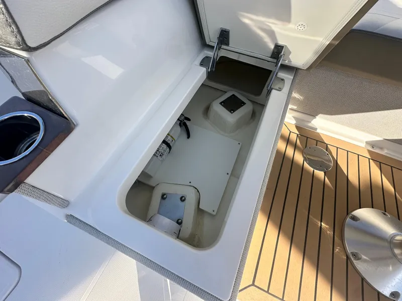 Slide: The Image of Open storage compartment on 2022 Tiara Yachts 43 LS with teak flooring. - 23