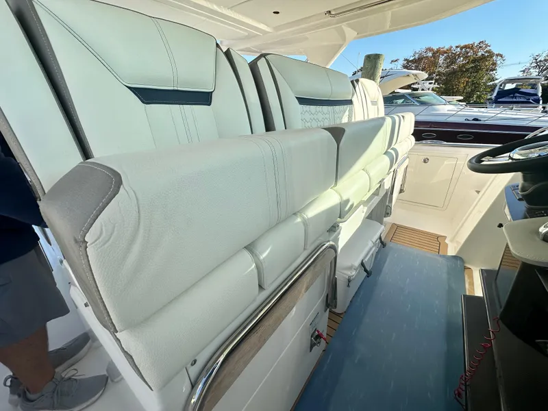 Slide: The Image of 2022 Tiara Yachts 43 LS interior seating with luxurious white upholstery. - 33