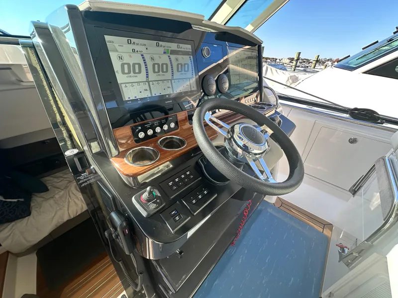 Slide: The Image of 2022 Tiara Yachts 43 LS helm with modern controls and navigation displays. - 36