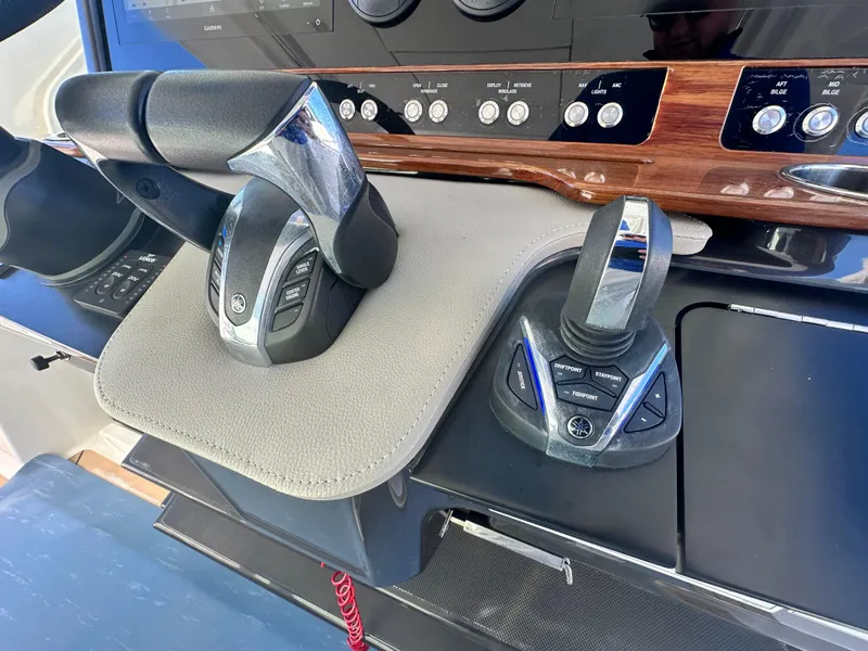 Slide: The Image of Control panel of 2022 Tiara Yachts 43 LS with modern throttle and joystick. - 37