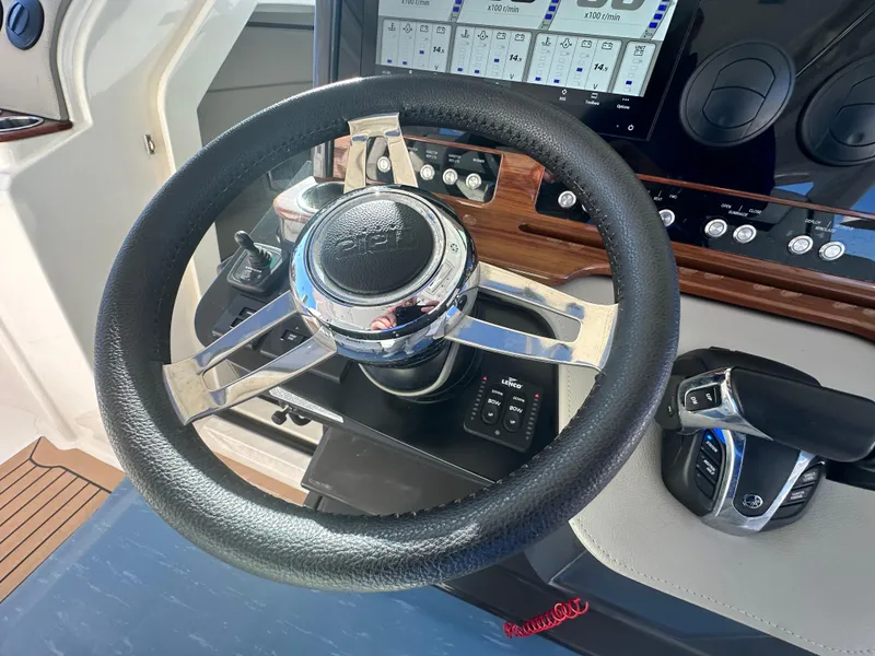Slide: The Image of Steering wheel of 2022 Tiara Yachts 43 LS, featuring modern dashboard controls. - 38