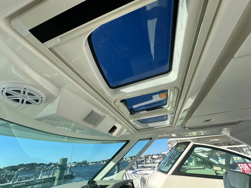 Slide: The Image of 2022 Tiara Yachts 43 LS interior with sunroof and waterfront view. - 40