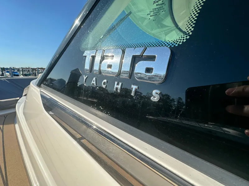 Slide: The Image of 2022 Tiara Yachts 43 LS logo on yacht window, sunny day reflection. - 42