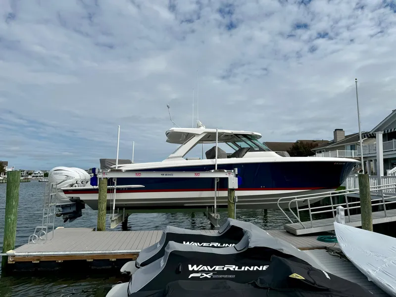 Slide: The Image of 2022 Tiara Yachts 43 LS docked, featuring sleek design and powerful engines. - 6