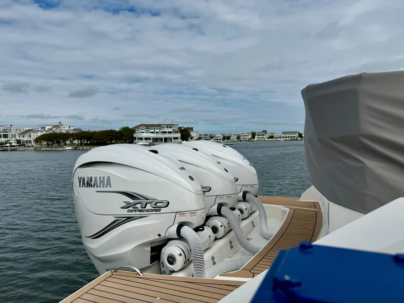 Slide: The Image of 2022 Tiara Yachts 43 LS with Yamaha XTO engines on a scenic waterfront. - 8