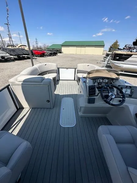 Slide: The Image of 2023 Starcraft SLS-3 pontoon boat interior with modern seating and steering console. - 11