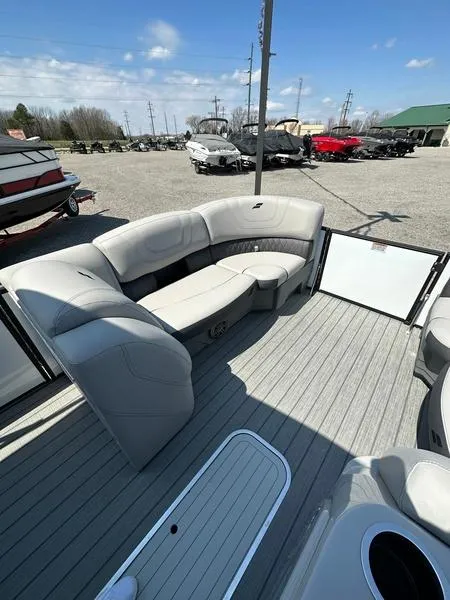 Slide: The Image of 2023 Starcraft SLS-3 boat interior with gray seating and open deck, parked outdoors. - 12