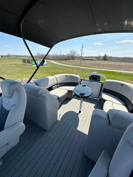 Slide: The Image of 2023 Starcraft SLS-3 pontoon boat interior with plush seating and table. - 7