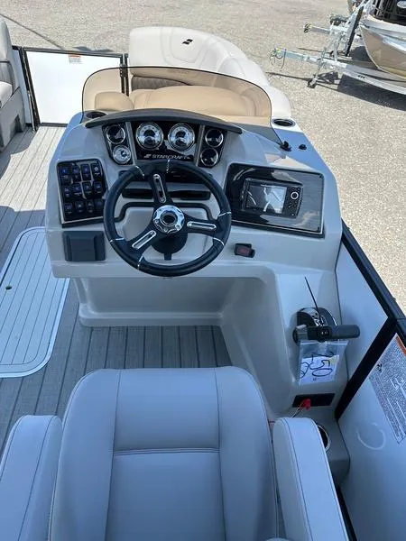 Slide: The Image of 2023 Starcraft SLS-3 boat dashboard with steering wheel and control panel. - 9