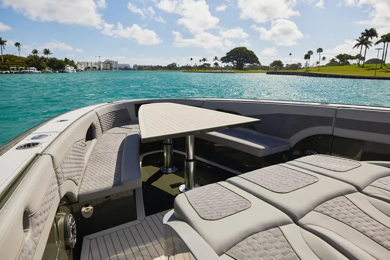 Slide: The Image of Luxurious 2025 Midnight Express 52' Vitesse yacht interior with elegant seating and table, overlooking serene waters. - 10