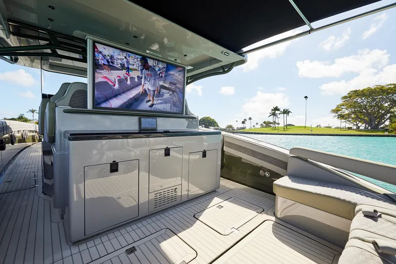 Slide: The Image of Luxurious 2025 Midnight Express 52' Vitesse yacht interior with TV and scenic water view. - 14