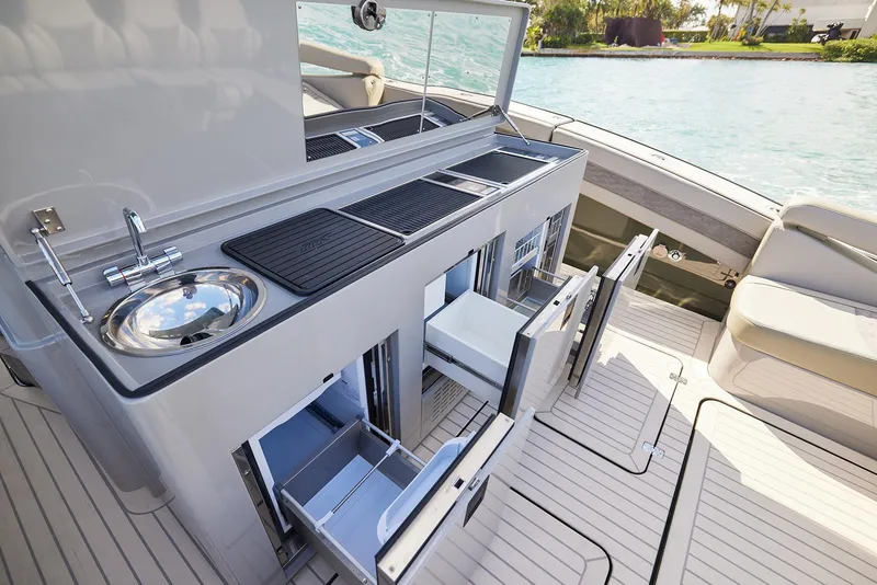 Slide: The Image of Luxurious 2025 Midnight Express 52' Vitesse yacht with sleek outdoor kitchen setup. - 17