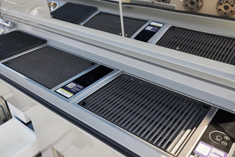 Slide: The Image of 2025 Midnight Express 52' Vitesse yacht interior with sleek, modern grill and control panels. - 18