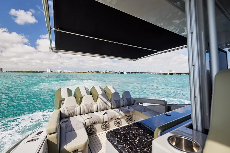 Slide: The Image of 2025 Midnight Express 52' Vitesse yacht cruising on turquoise waters under a sunny sky. - 21