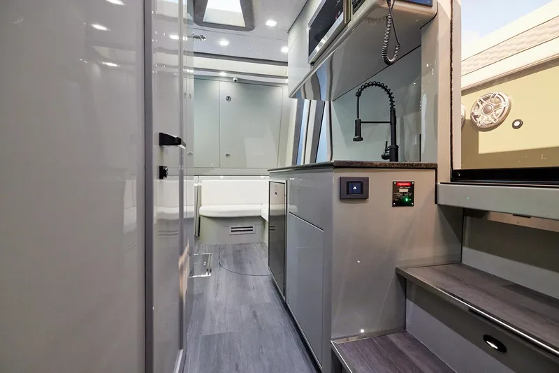 Slide: The Image of Luxurious interior of 2025 Midnight Express 52' Vitesse yacht, featuring modern kitchen and sleek design. - 23