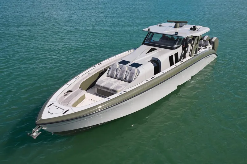 Slide: The Image of 2025 Midnight Express 52' Vitesse luxury boat on clear blue water. - 3