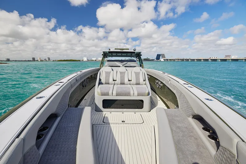 Slide: The Image of 2025 Midnight Express 52' Vitesse luxury boat on turquoise water under blue sky. - 7
