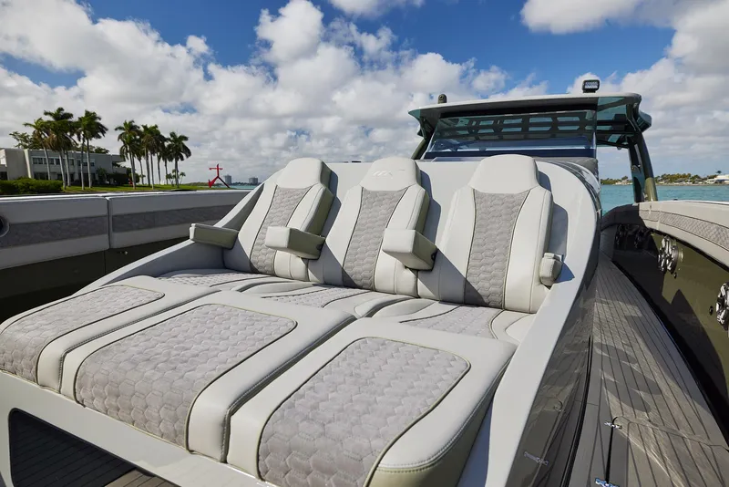 Slide: The Image of Luxurious seating on 2025 Midnight Express 52' Vitesse yacht under a partly cloudy sky. - 8