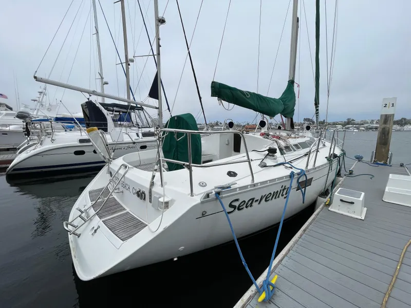 The Image of Beneteau Oceanis 390 sailboat docked, 1991 model, named "Sea-renity," with green sail cover. - 0