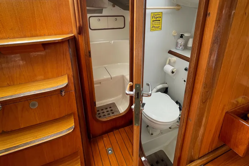 Slide: The Image of 1991 Beneteau Oceanis 390 yacht bathroom with wooden interior and compact design. - 16