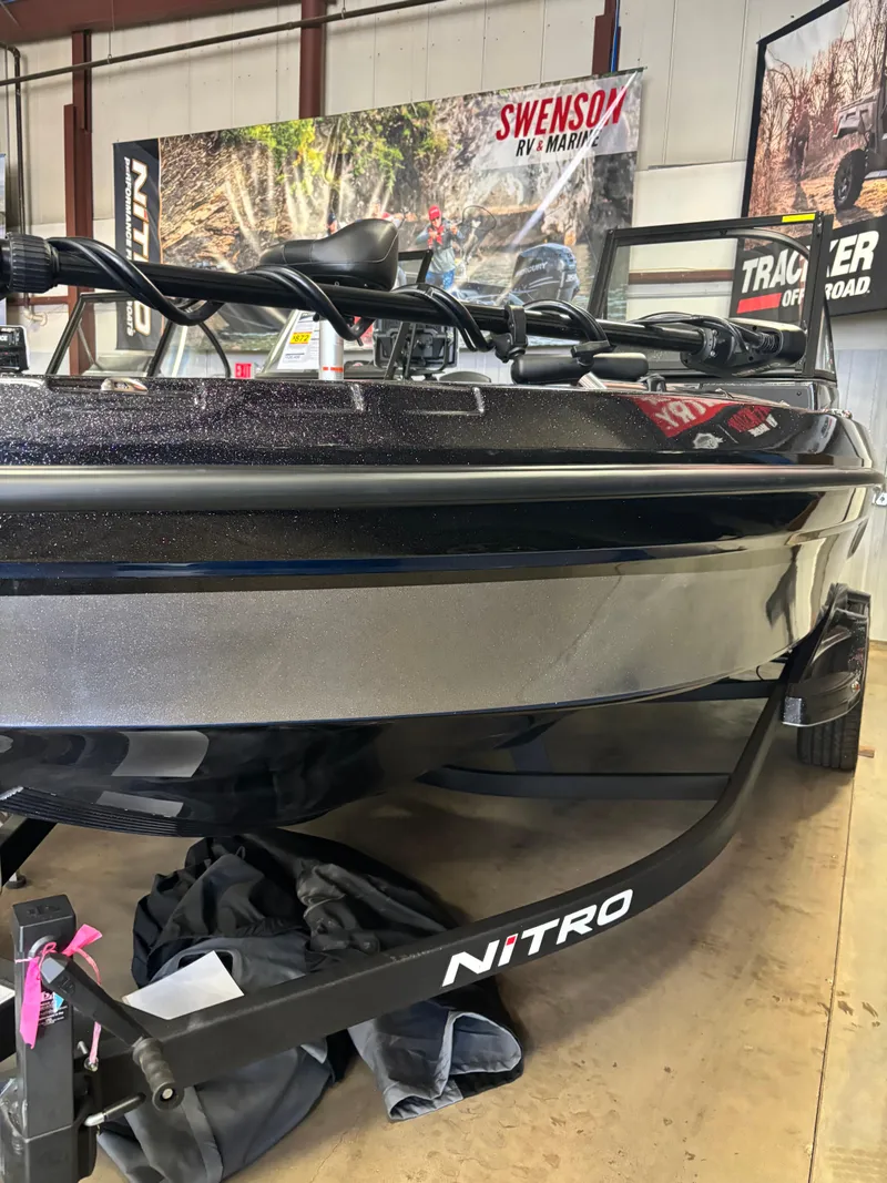 Slide: The Image of 2025 Nitro ZV21 Pro boat displayed indoors with promotional banners. - 0
