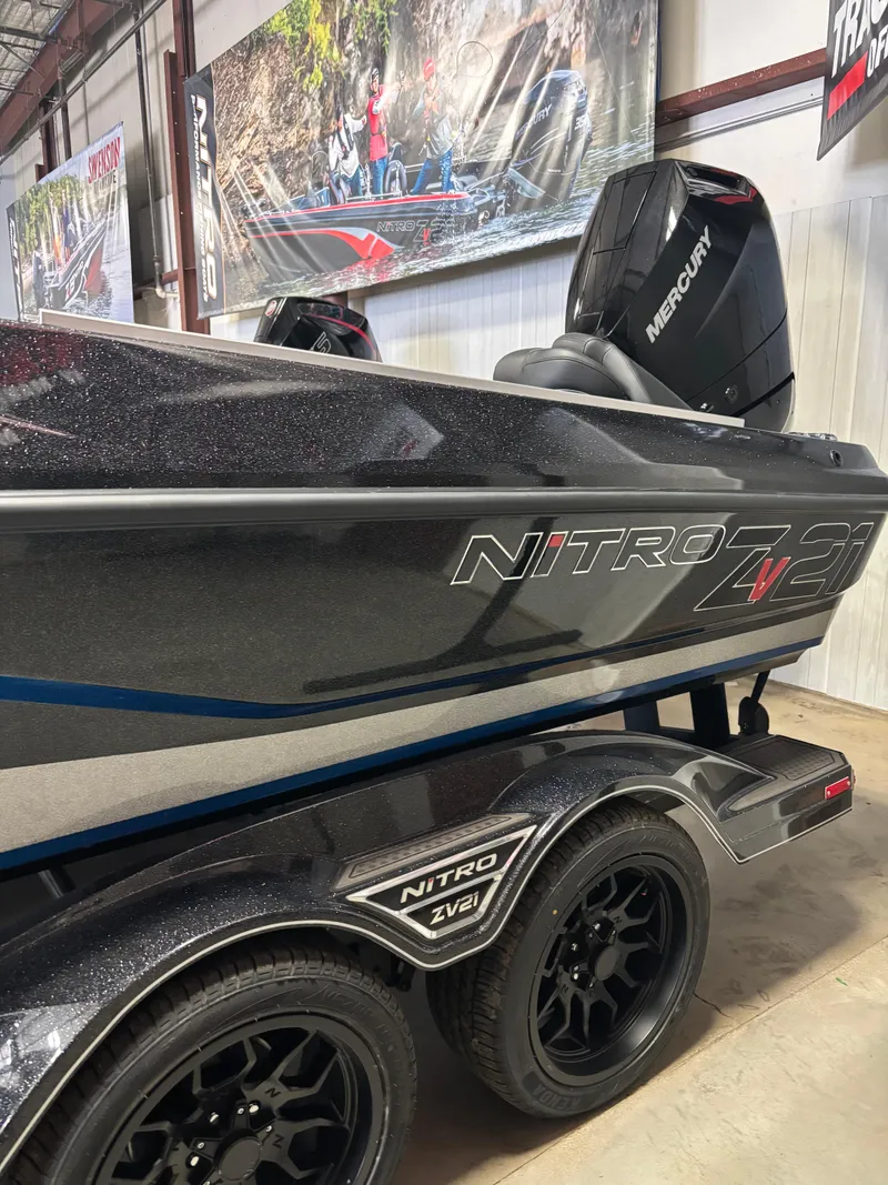 Slide: The Image of 2025 Nitro ZV21 Pro boat with Mercury engine on display in showroom. - 1