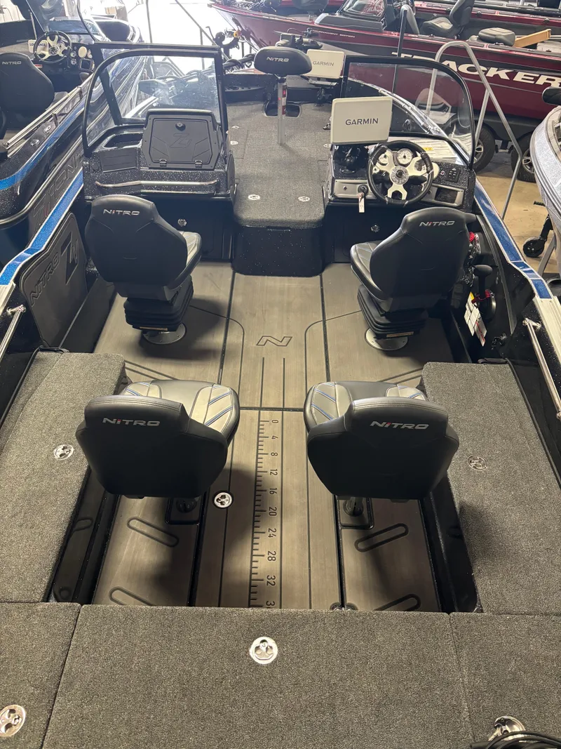Slide: The Image of 2025 Nitro ZV21 Pro boat interior with four seats and steering console. - 6