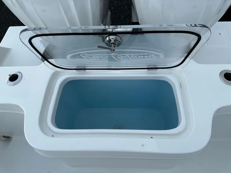 Slide: The Image of Open storage compartment on 2025 Pair Customs 27 boat, featuring a transparent lid. - 13