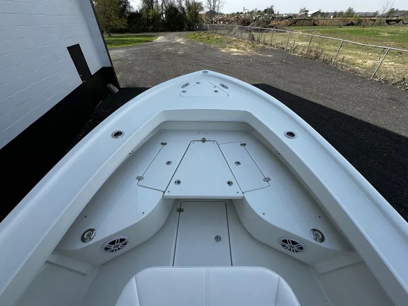 Slide: The Image of Bow view of 2025 Pair Customs 27 boat, featuring sleek white design and spacious deck. - 17