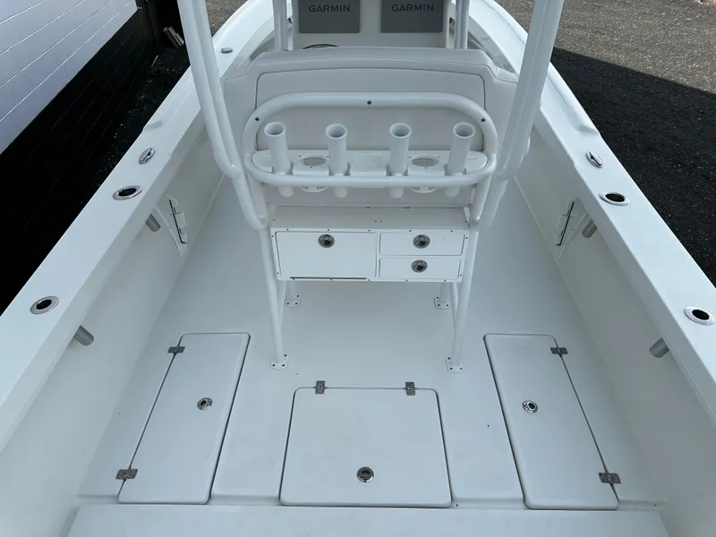 Slide: The Image of 2025 Pair Customs 27 boat interior with rod holders and storage compartments. - 11