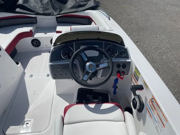 Slide: The Image of 2022 Hurricane SS 192 RL OB boat cockpit with steering wheel and dashboard controls. - 6