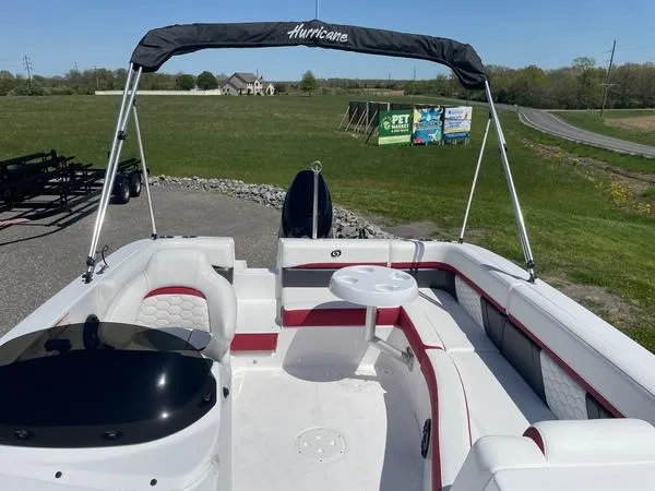 Slide: The Image of 2022 Hurricane SS 192 RL OB boat with seating and canopy, parked on a grassy area. - 8
