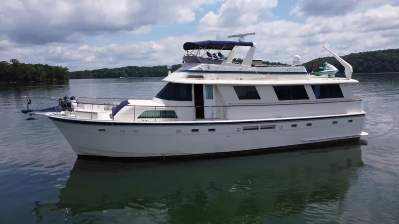 Slide: The Image of 1987 Hatteras 63 Motor Yacht on calm water under cloudy sky. - 15