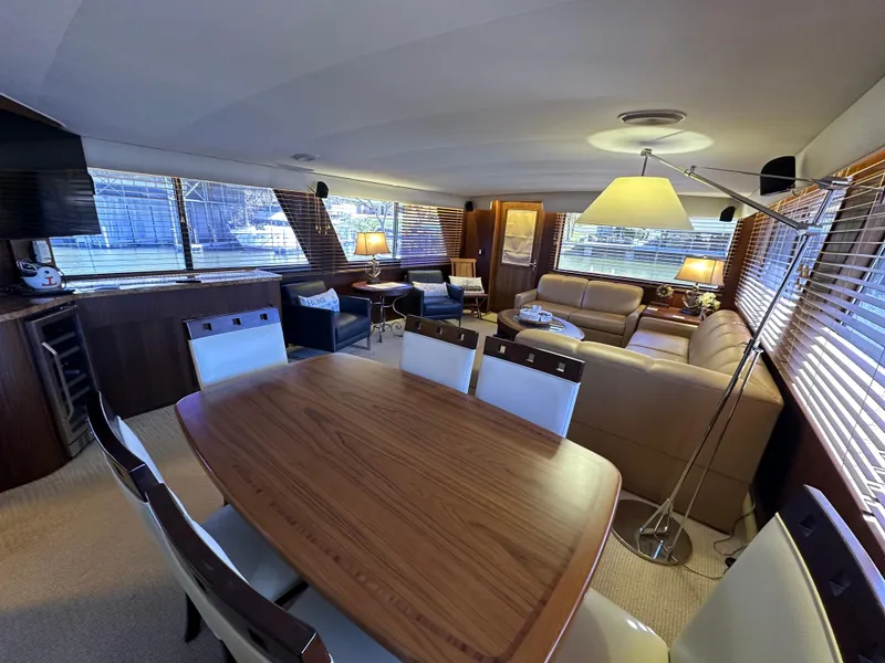 Slide: The Image of Luxurious interior of a 1987 Hatteras 63 Motor Yacht with elegant dining and seating areas. - 16