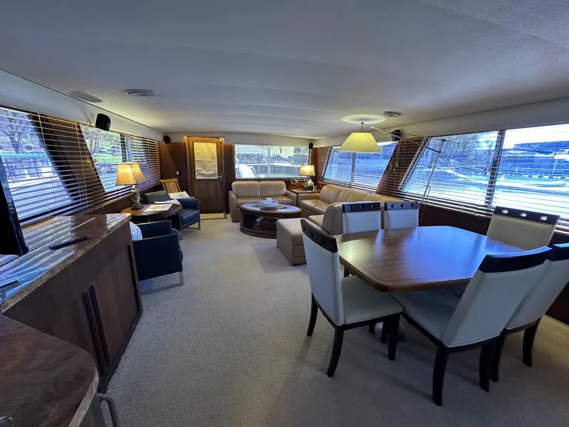 Slide: The Image of Luxurious interior of a 1987 Hatteras 63 Motor Yacht with elegant dining and seating areas. - 17